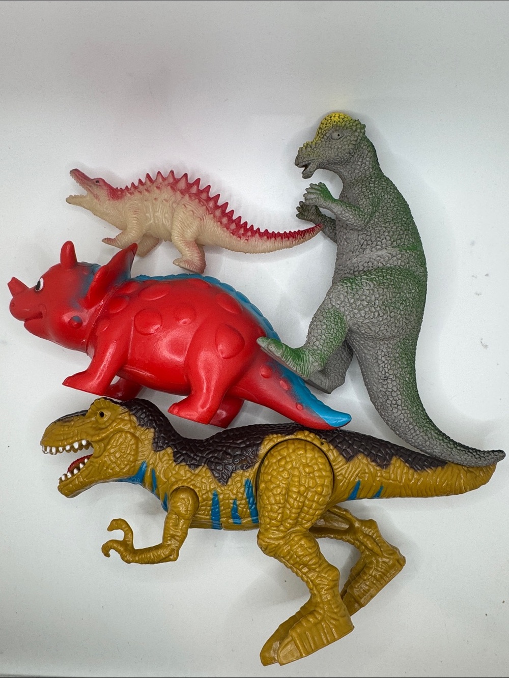 Prehistoric Playtime: 4-Piece Vintage Toy Dinosaur Collection